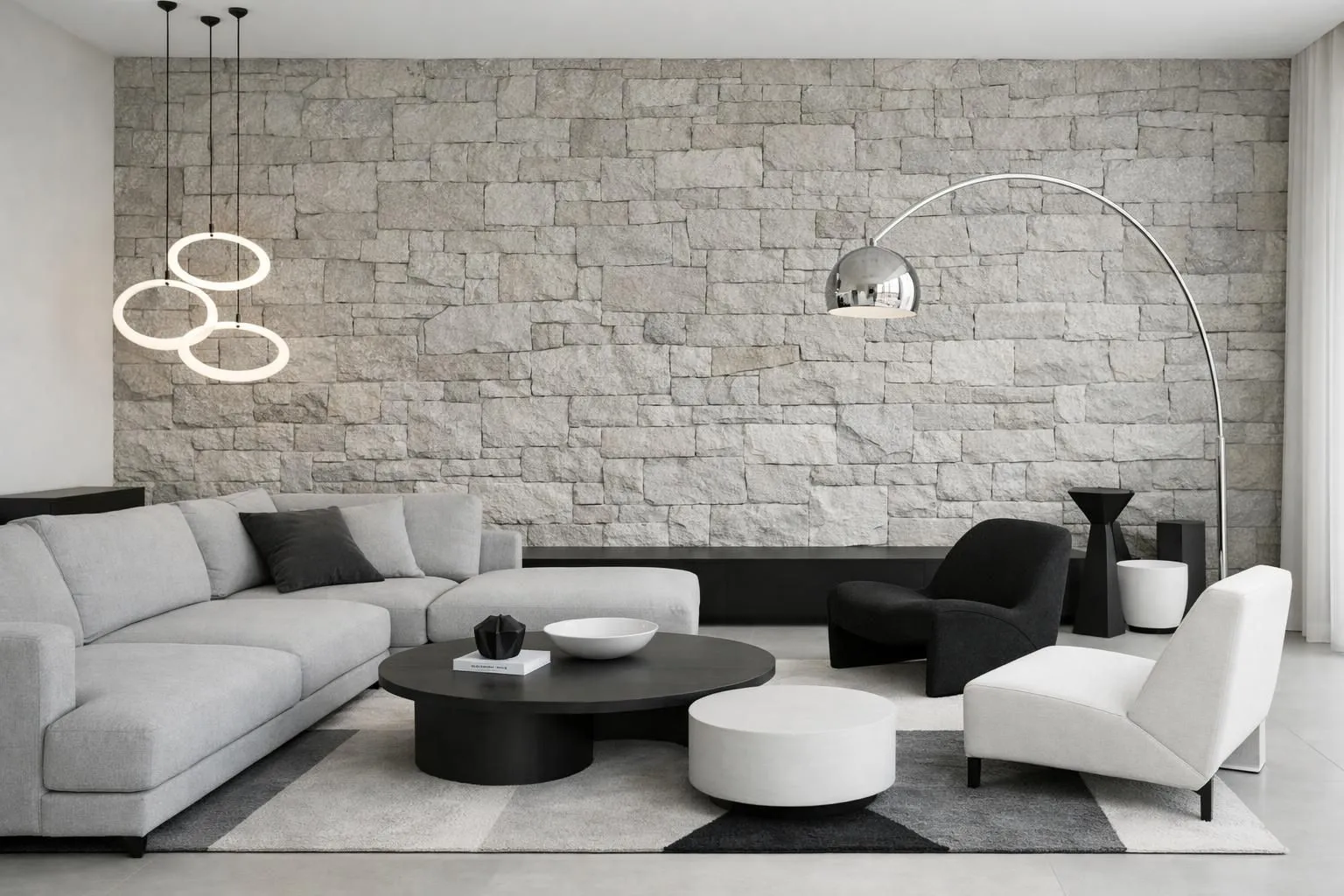 Minimalist living room with stone wall, modern furniture, and lighting.