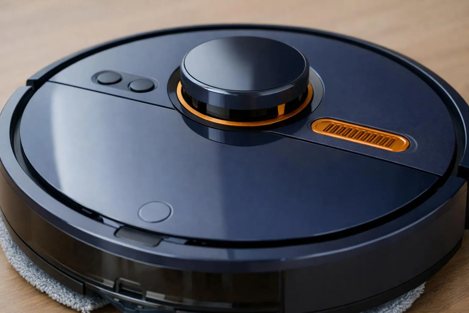 Sleek, black robotic vacuum cleaner with control panel and sensors.