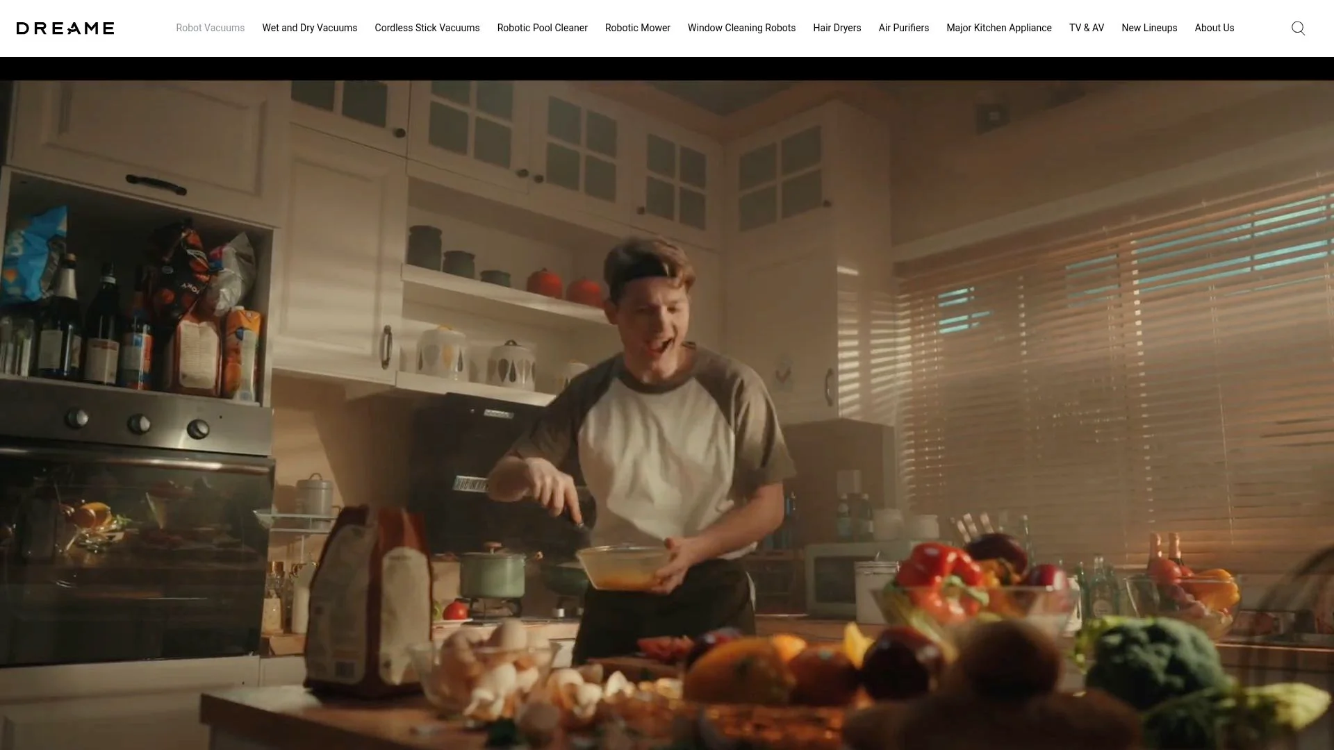 A person cooking in a well-equipped kitchen surrounded by fresh produce.